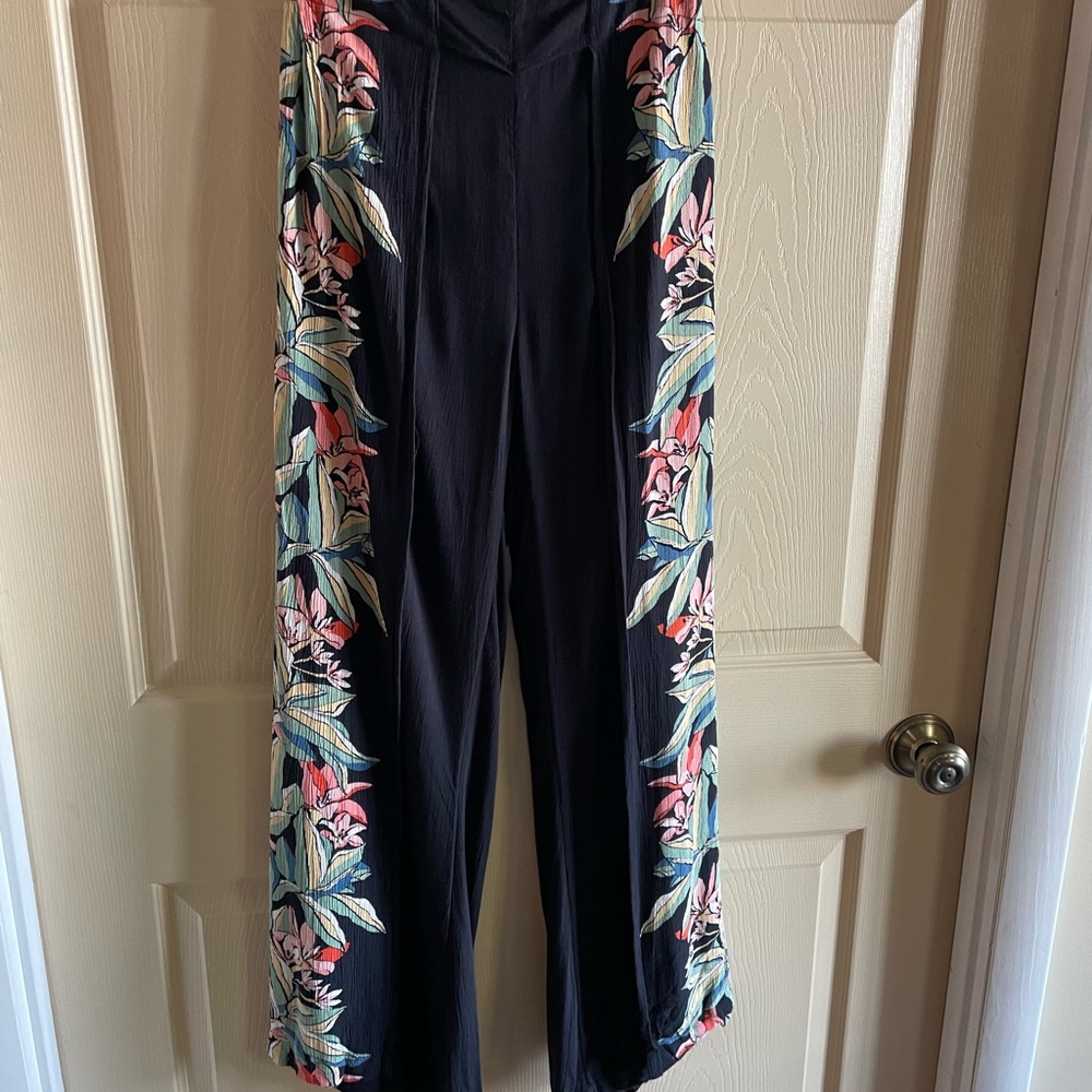 Billabong split black and floral wide leg pants.